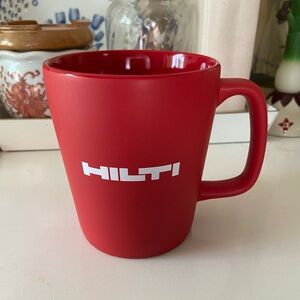 Red coffee mug Hilti company specializing professional construction technology.